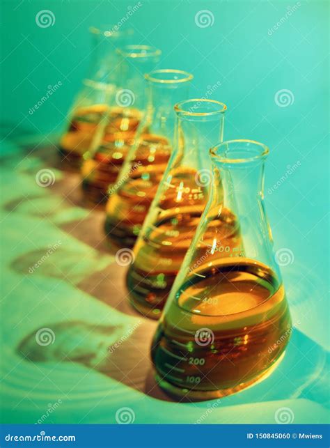 Illustrative Selective Focus Image Of Chemical Flasks On Green Stock
