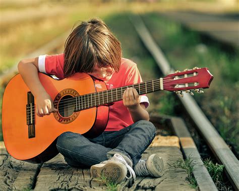 Young Child Playing Acoustic Guitar Photograph By Predrag Popovski