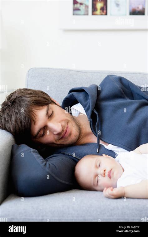 Father And Baby Sleeping On Couch Stock Photo Alamy