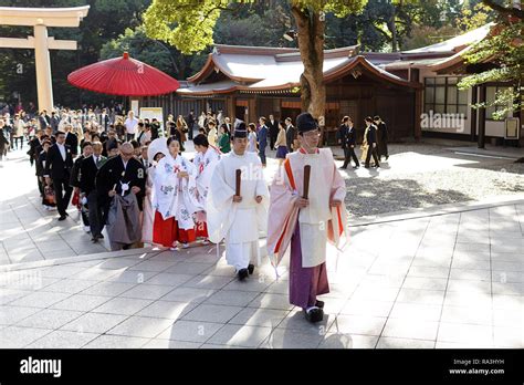 Shinto Wedding Procession With Bride Wearing The Traditional Watabōshi