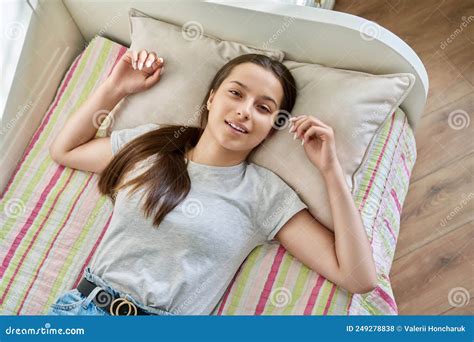 Teenage Girl Sleeping At Home In Bed Calm Teenager Looking At Camera