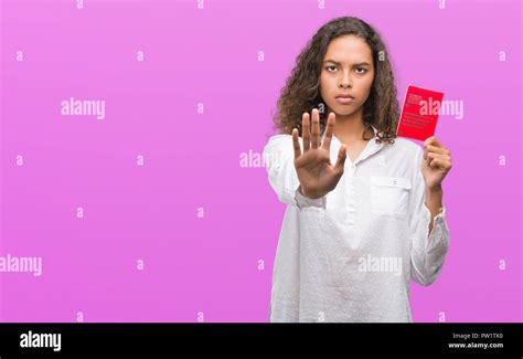 Young Hispanic Woman Holding Passport Of Switzerland With Open Hand