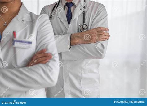 Two Diverse Doctors Wearing Their White Coats And Stethoscopes Stock