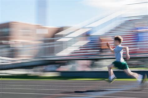 Young Boy Sprints In A Running Race Del Colaborador De Stocksy Cara