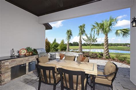 An Outdoor Patio With Grill And Firepit From Cardel Homes Kallista At