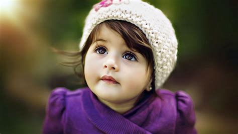 Cute Adorable Girl Baby Is Looking Up Wearing Purple Dress