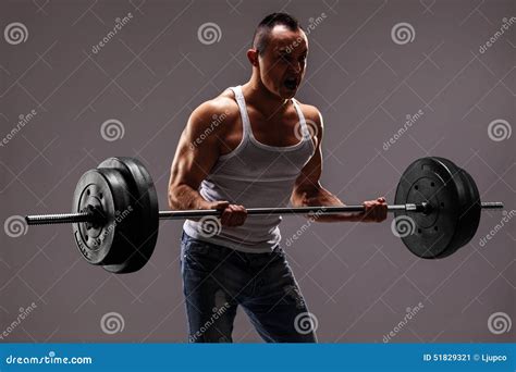 Strong Muscular Man Lifting A Heavy Barbell Stock Photo Image 51829321