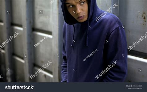 Suspicious Teenager Hiding Looking Around Secretly Stock Photo