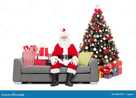 Santa Sitting On A Sofa By A Christmas Tree