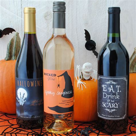 Three Bottles Of Wine Sitting On Top Of A Table Next To Pumpkins And