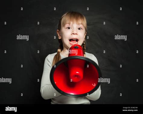 Little Girl Shouting Through A Megaphone On Black Background Kid With