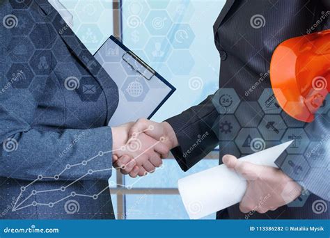 Handshake Between Businessman And Engineer Builder Stock Photo