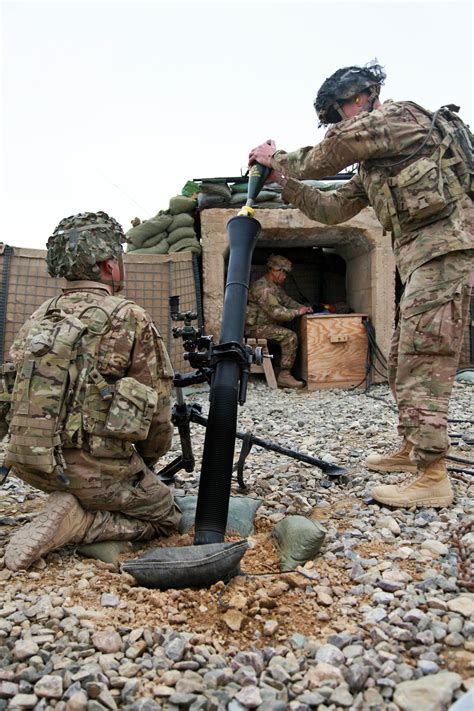 U S Army Spc Shay Waite Right Prepares To Fire An 81mm Mortar Round During Training On