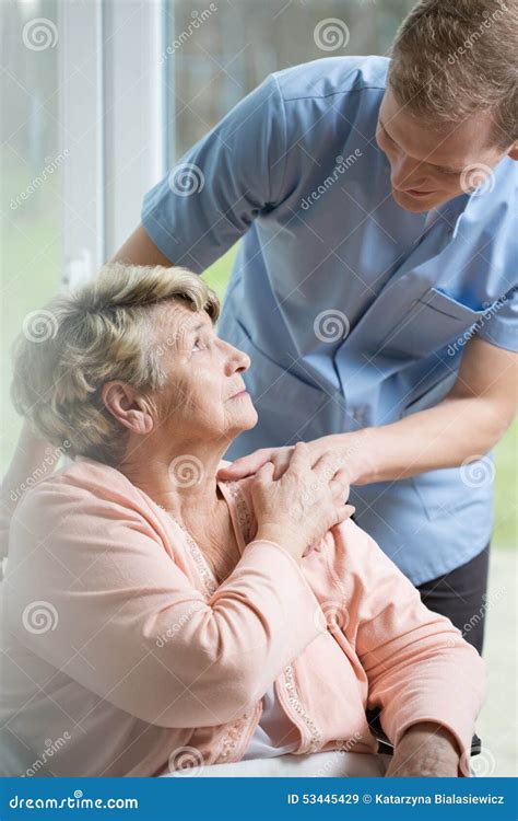 Nurse Caring For An Elderly Patient In Home Royalty Free Stock Image