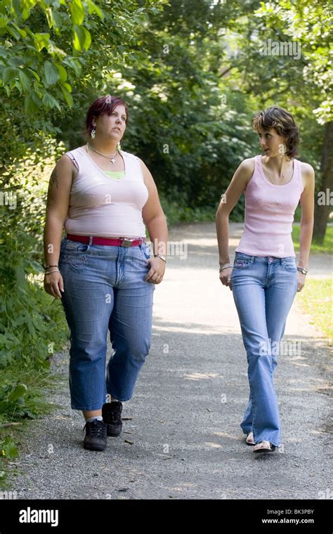 Obese And Skinny Women Walking Routine In Park And Chatting Full Stock