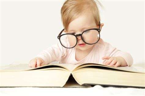 Best Baby Reading A Giant Book While Wearing Glasses Stock Photos
