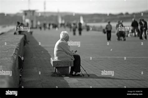 old lady alone Mountbatten Pier Plymouth sitting with walking sticks in