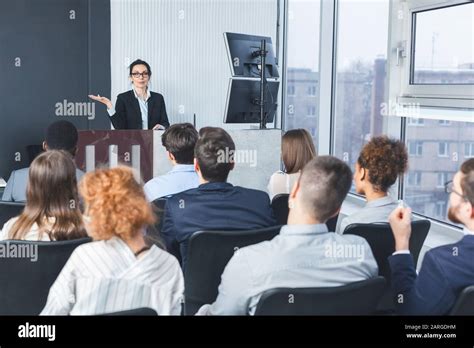 Business Lecture Coach Giving Presentation To Young Staff Stock Photo