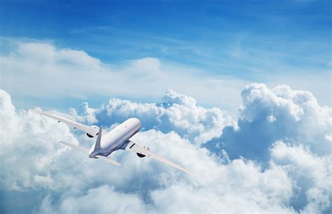 Commercial Airplane Flying Above Clouds Stock Photo Download Image