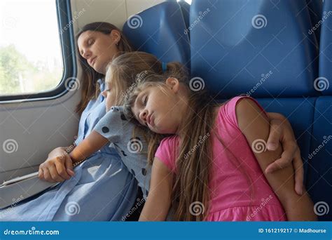 Mom And Two Daughters Fell Asleep In An Electric Train Car Stock Image