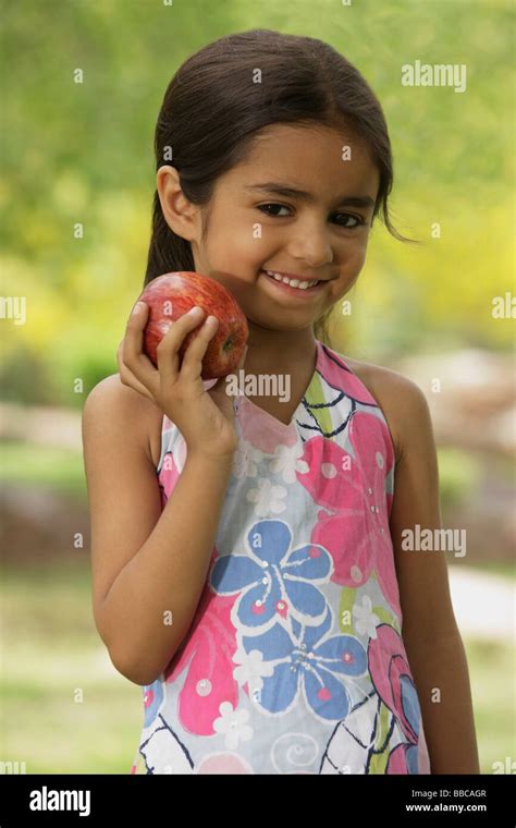 Little Girl With Apple Stock Photo Alamy