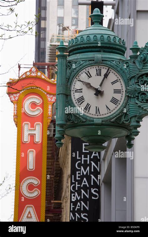 The Marshall Field Building Clock And Chicago Theatre Behind Chicago