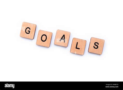 The Word Goals Spelt With Wooden Letter Tiles Over A White Background