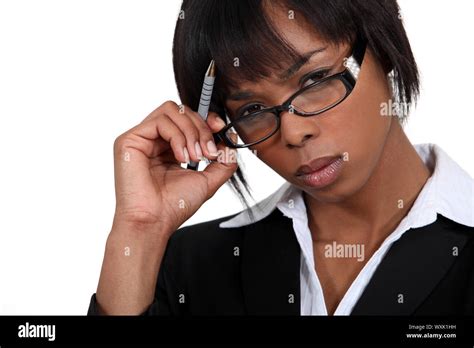 Stern Businesswoman Touching Her Glasses Stock Photo Alamy