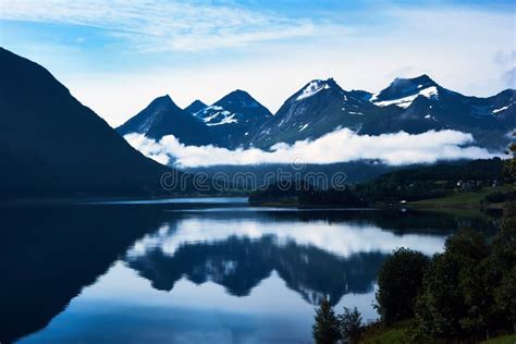 Beautiful Blue Landscape With Snow Capped Mountains And Thier