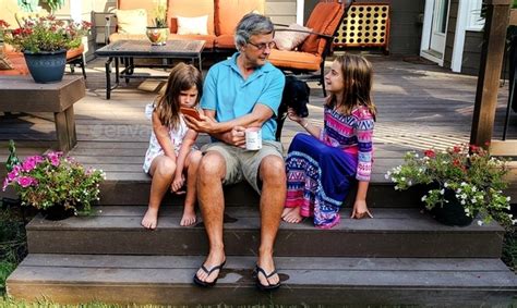 Active Babyboomer With His Gen Z Grandkids On Backyard Deck Of Home