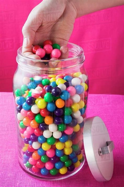 Hand Taking Coloured Bubble Gum Balls Out Of Jar Stock Photo Dissolve