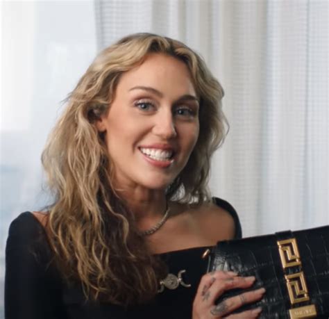 Miley Cyrus Shows Off Her New Versace Bag For British Vogue