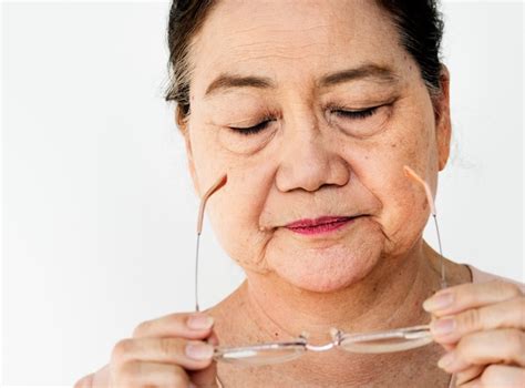 Premium Photo Senior Adult Asian Woman Taking Off Eyeglasses