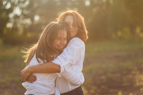 Mom Hugging Daughter Raising Teens Today