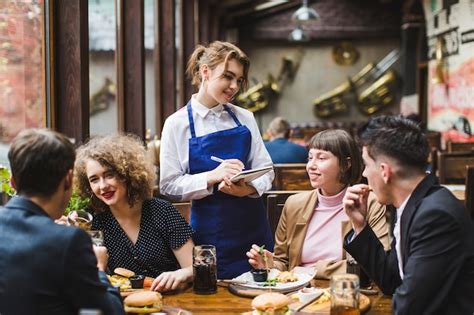 Waitress Taking Orders From People In Restaurant Photo Free Download