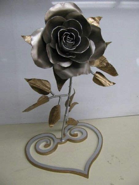 There Is A Metal Rose With Leaves On It