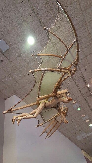 A Large Wooden Dragon Sculpture Hanging From The Ceiling