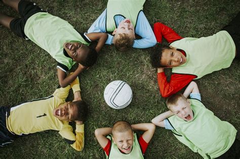 Junior Football Team Lying Around A Football Free Photo Rawpixel