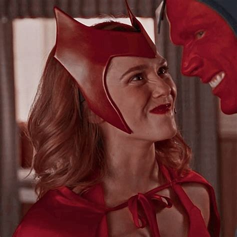 A Woman In A Red Dress With A Cat Mask On