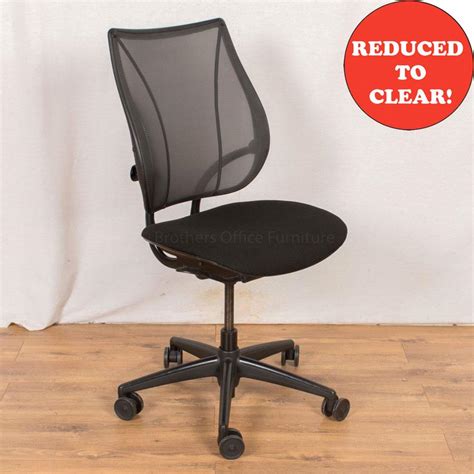 An office chair with bold stitching detail and fully upholstered arms, adjustable headrest, full recline, and hidden footrest. Humanscale Liberty Mesh Office Chair - No Arms