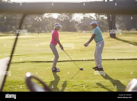 Mature Man Teaching Woman To Play Golf Stock Photo Alamy