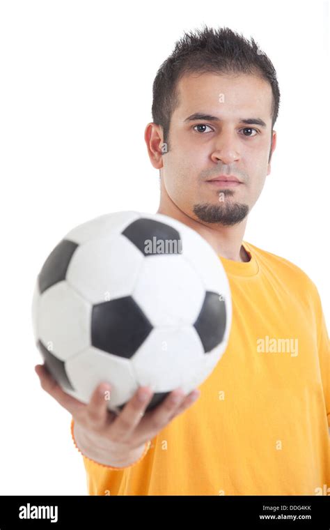 Portrait Of Young Man Holding Soccer Ball Over White Background Stock