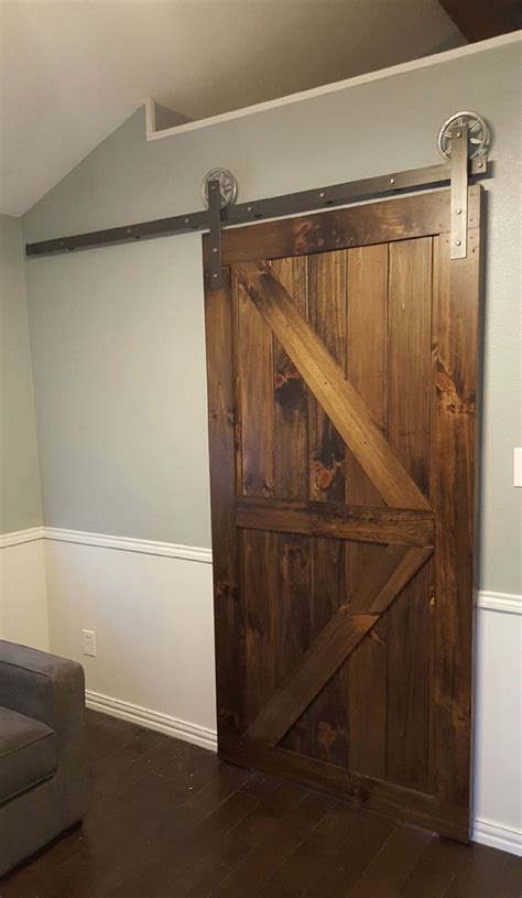 I actually took the existing door off the hinges and installed the pipe track with casters but you can also build this door fairly easily with just two steps, see down below for detailed plans. vintage sliding barn door hardware rustic black barn ...
