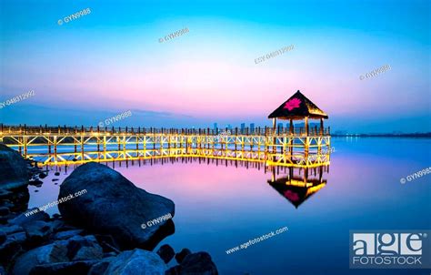 Tranquil Lake And Wooden Trestle Evening Landscape Stock Photo