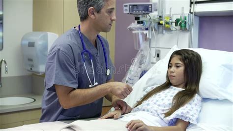 Young Girl Talking To Male Nurse In Hospital Room Stock Footage Video