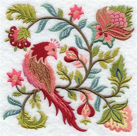 An Embroidered Design With Flowers Leaves And A Bird Sitting On Its Back