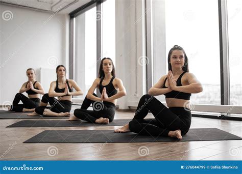 Yoga Companions Working Out Together In Meditation Room Stock Image