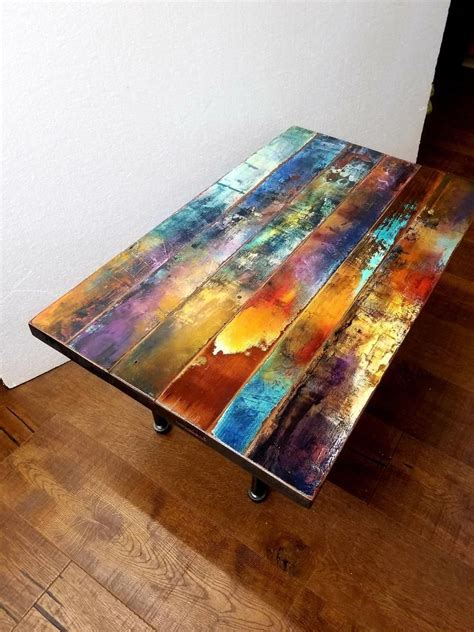 This eclectic modern cube table was created of reclaimed blue pine wood with a hand painted design of washed muted colours, giving it an artful charm and patina fusing a modern rustique sophistication. Whimsical jewel tone painted coffee table. abstract ...