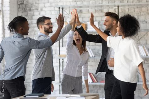 Plakat Excited Successful Multiracial Business People Giving High Five