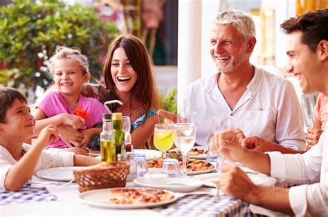 What restaurants have family meals. Multi Generation Family Eating Meal At Outdoor Restaurant ...